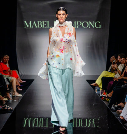 Model walking on Runway in Mabel Brempong high waist Linen Pants and floral Organza top